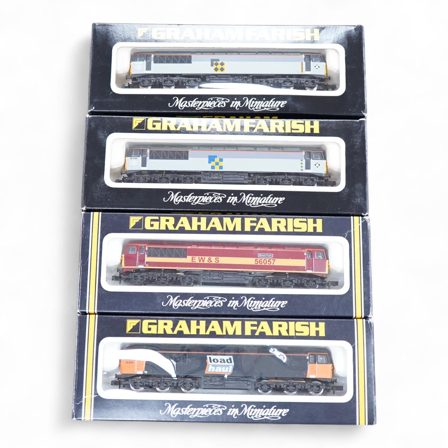 Four boxed Graham Farish N gauge railway class 56 diesel locomotives; a Load Haul, 56055, (805D), an EWS, British Fuels 56057 (805E), a Coal Sector, 56 092, (8057) and a Construction Sector, 56 059 (8056).